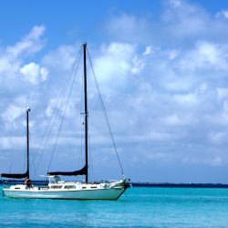 A sailing ship on the sea under the sunlight and a cloudy sky at daytime