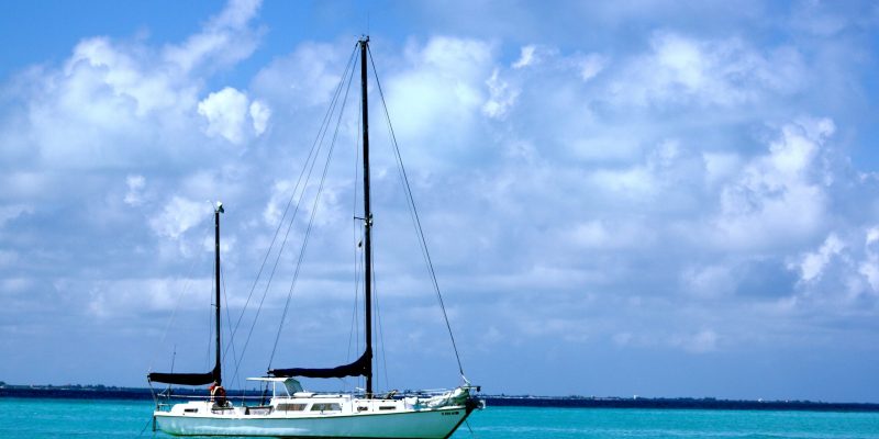 A sailing ship on the sea under the sunlight and a cloudy sky at daytime
