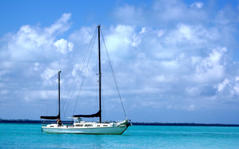 A sailing ship on the sea under the sunlight and a cloudy sky at daytime